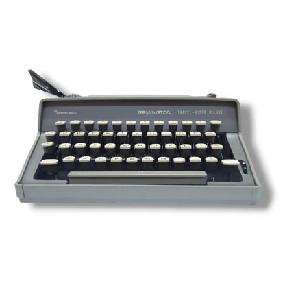 Vintage Remington Travel-Writer Deluxe manual typewriter, low front view showing cream keys and compact design