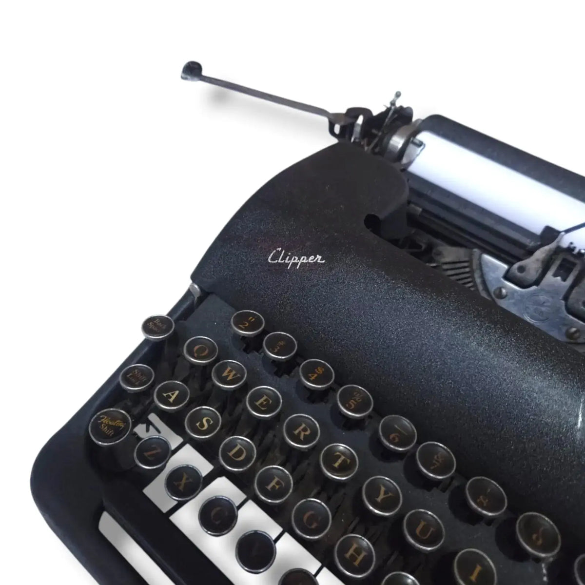 Smith Corona Clipper typewriter close-up showing round metal keys, black textured body and classic Clipper branding