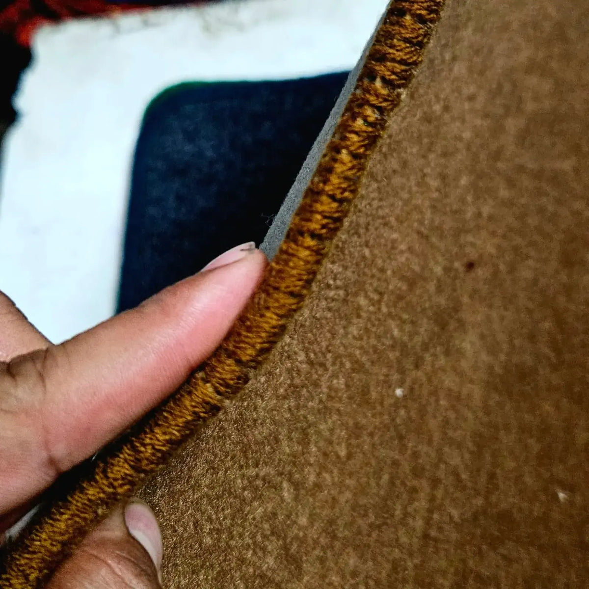 Close view of thick stitched edge on premium typewriter table mat showing durable interlocked construction