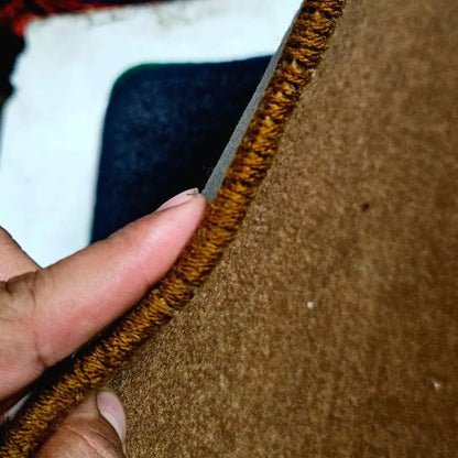 Close view of thick stitched edge on premium typewriter table mat showing durable interlocked construction