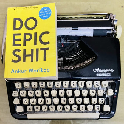 Olympia Splendid 66 typewriter with book on carriage, vintage portable manual English typing machine for writers