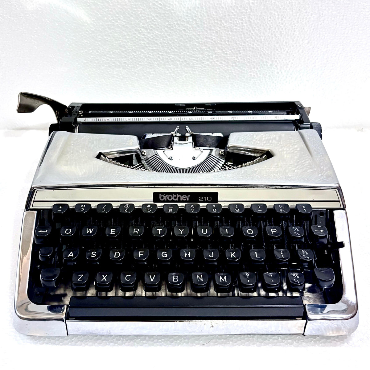Mirror chrome Brother 210 portable typewriter with black keys, restored by RR Typewriter Mart for collectors