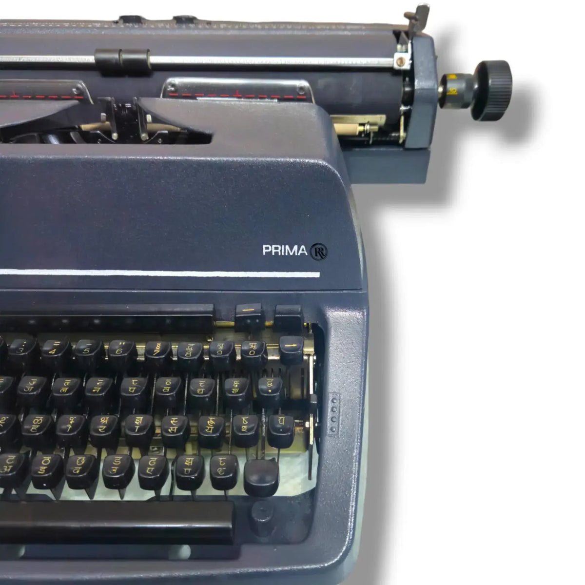 Godrej Prima Hindi brief carriage typewriter side close-up in factory grey finish