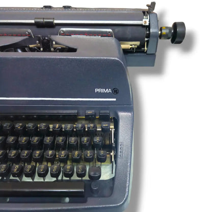 Godrej Prima Hindi brief carriage typewriter side close-up in factory grey finish