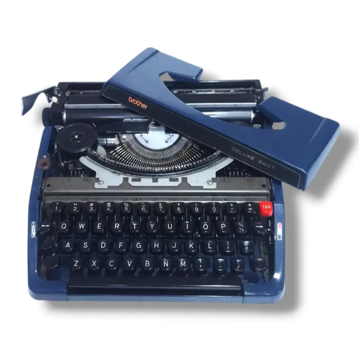 Brother Deluxe 240T typewriter with top cover removed, showing ribbon spool, typebars and internal mechanism