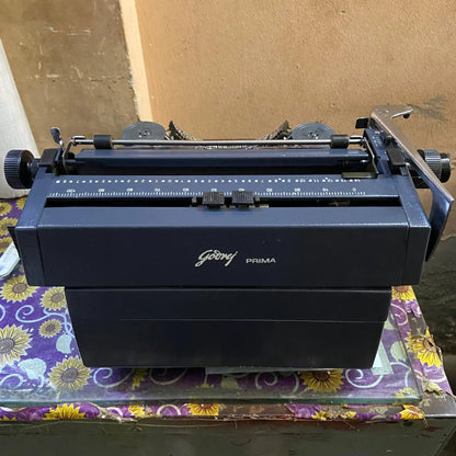 Rear angle of Godrej Hindi Typewriter showing sturdy metal construction and carrying handle
