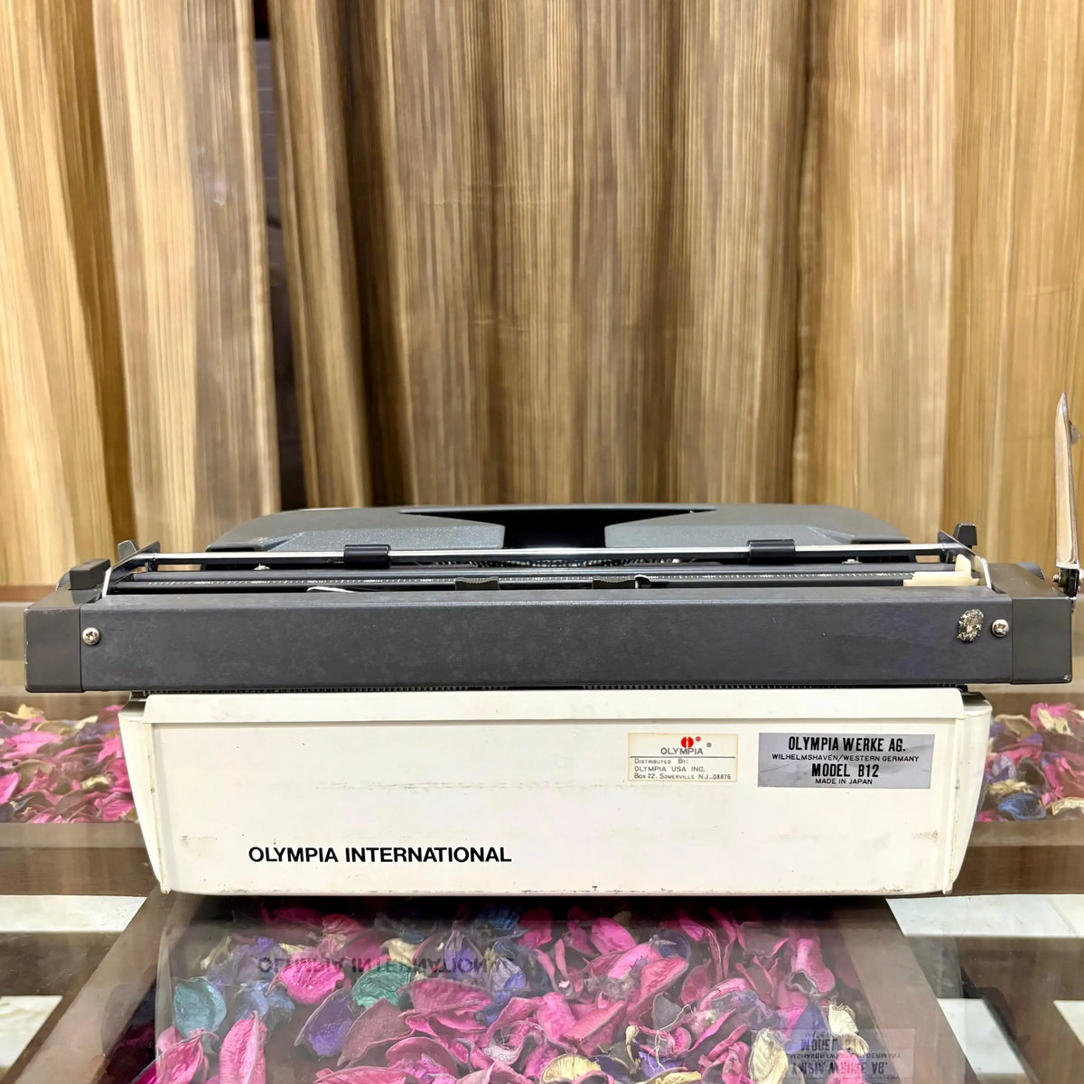 Rear view of Olympia B12 portable manual typewriter showing Olympia International branding and Made in Japan label