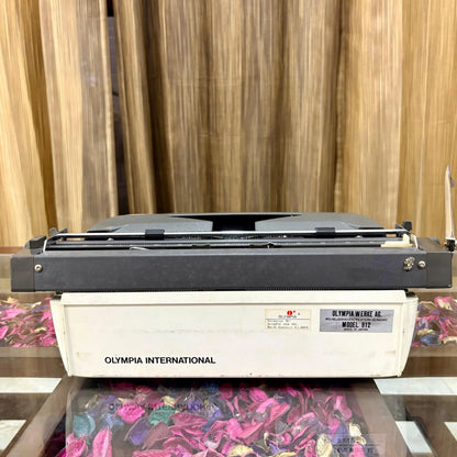 Rear view of Olympia B12 portable manual typewriter showing Olympia International branding and Made in Japan label