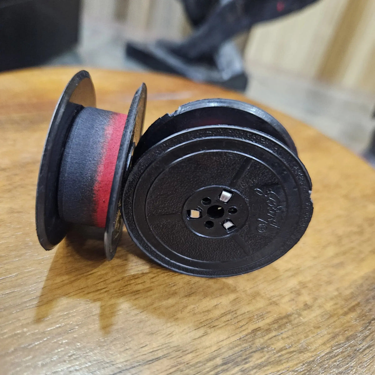 Close-up of red and black typewriter ribbon roll spool, ribbon for typing machine from ribbon roll store