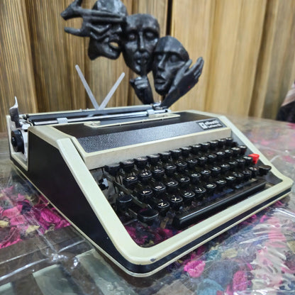 Angled view of Olivetti portable typewriter showing English keyboard and leather finish, RR Typewriter Mart