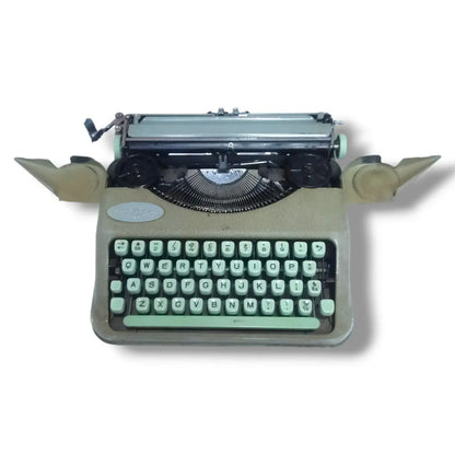 Hermes Baby Rocket manual typewriter with ribbon covers open, showing internal mechanism, spools and English keyboard