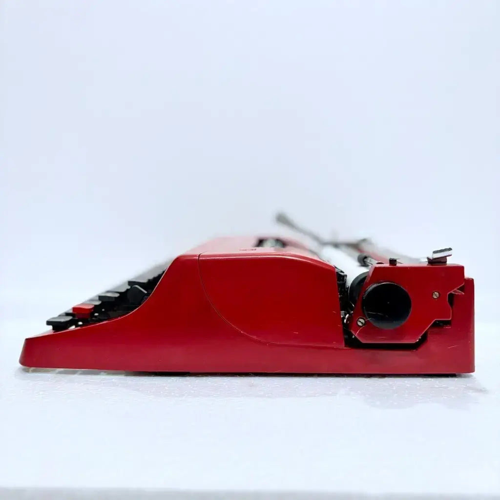 Low angle side view of Olivetti Lettera 32 Rasso Red Typewriter highlighting keys and finish, RR Typewriter Mart
