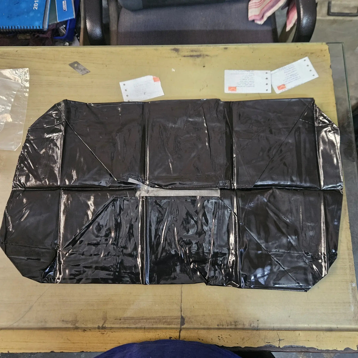 Fully unfolded black rexine dust cover for policy carriage typewriters during storage and maintenance