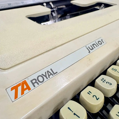 Royal Junior semi portable typewriter close-up showing model branding and cream vintage body, from RR Typewriter Mart.