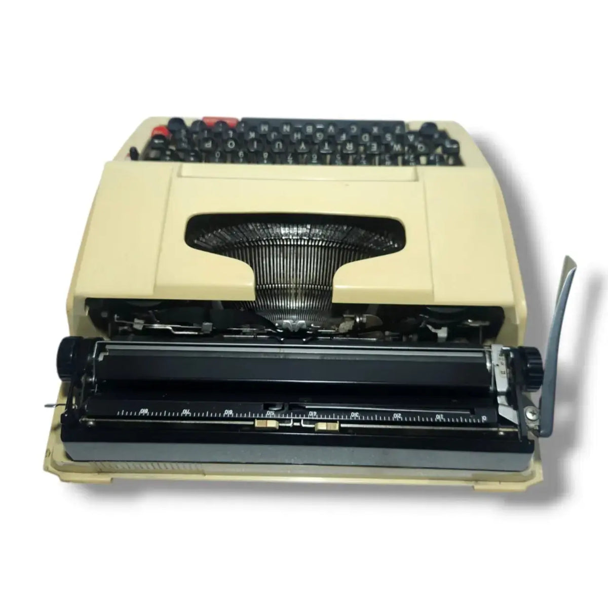 Close rear angle of Brother typewriter showing platen, carriage scale, and sturdy portable design