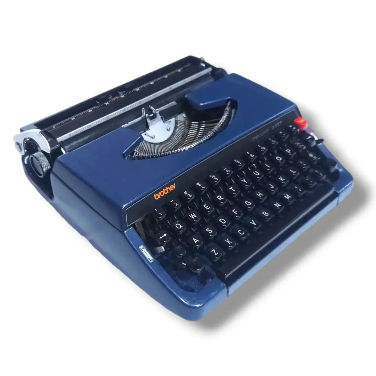 Vintage Brother Deluxe 240T manual typewriter in blue, angled view with English keyboard and portable body