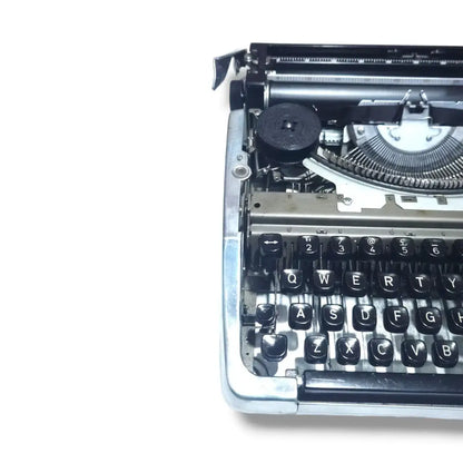Close-up of Brother 100 chrome typewriter with ribbon spool, English manual typing machine showing internal mechanism