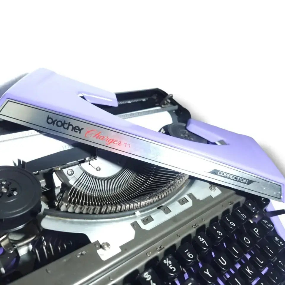 Brother Charger 11 vintage mauve typewriter close-up with correction feature and metal keys