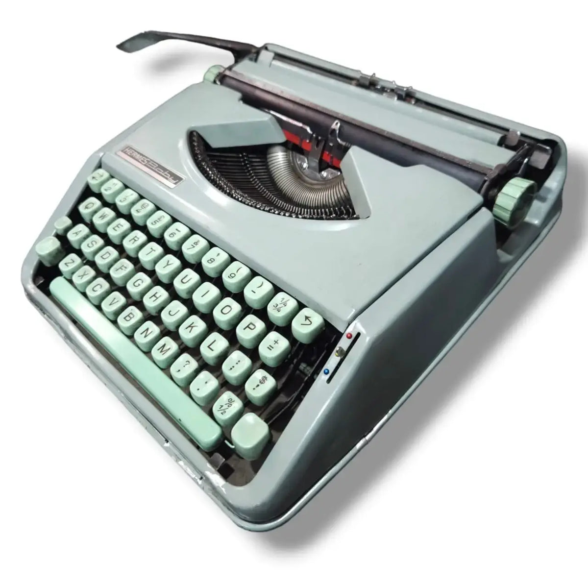 Angled view of Hermes Baby Typewriter with mint keyboard, imported manual English typing machine from typewriter seller