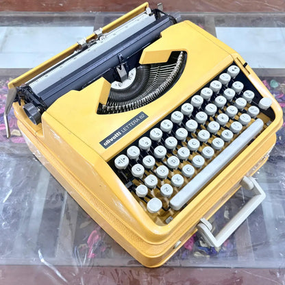 Angled Olivetti Lettera 82 yellow typewriter with white keyboard, vintage typewriter shop RR Typewriter Mart
