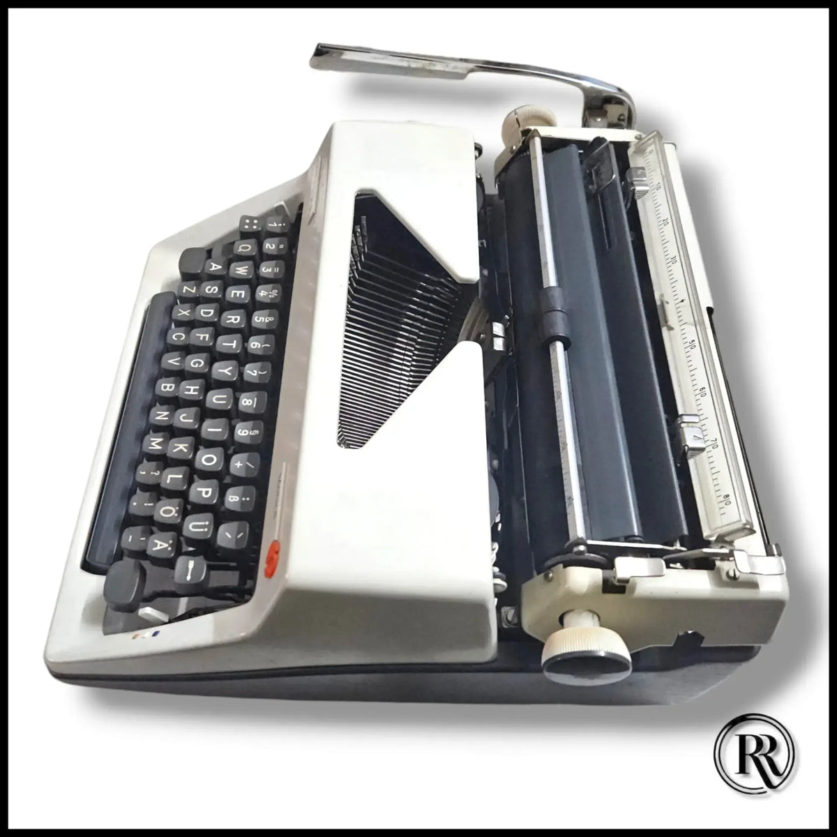 Side view of Olympia Monica vintage typewriter showing carriage, platen and keyboard on German manual typing machine