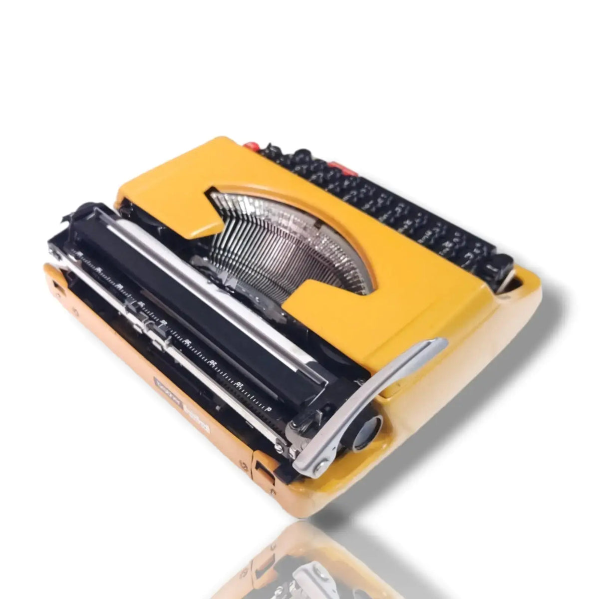 Brother Deluxe 250 TR portable typewriter rear view showing yellow body, carriage, typebars and mechanical assembly
