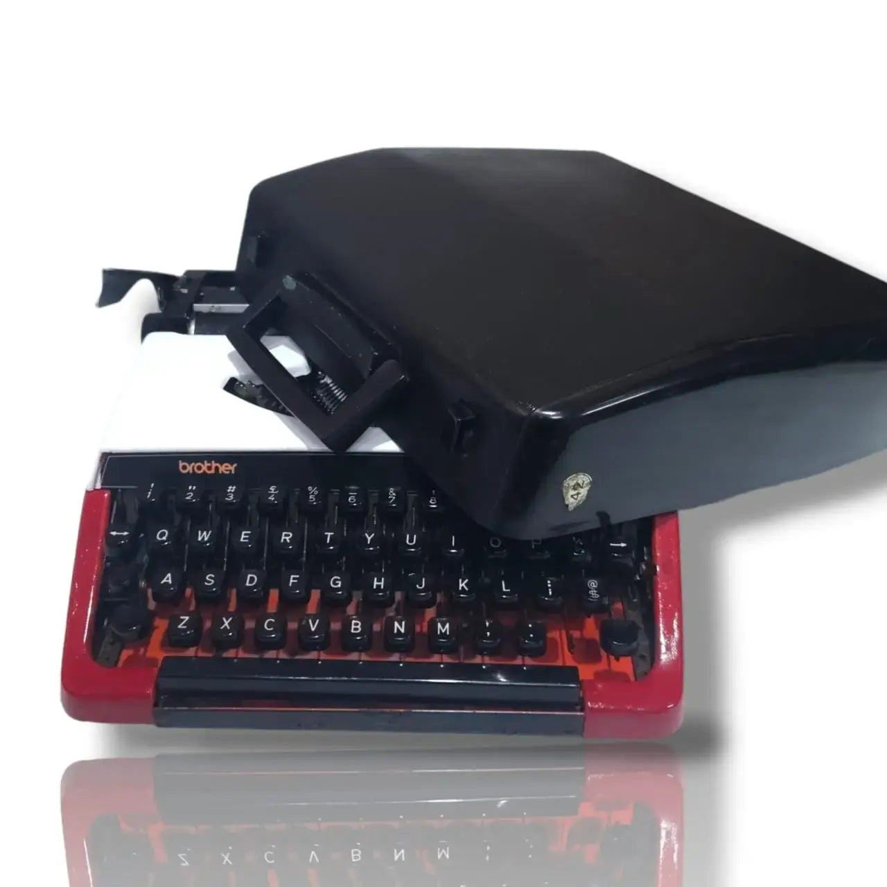 Brother Deluxe 220 Swiss vintage typewriter with black carry case, red and white body and classic QWERTY keyboard