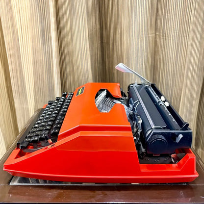 Underside of Brother Young Elite 513 scarlet red portable typewriter, showing base panel and construction details | RR Typewriter Mart