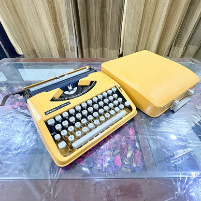 Yellow Olivetti Lettera 82 Brazilian-made manual typewriter photographed at an angle, RR Typewriter Mart