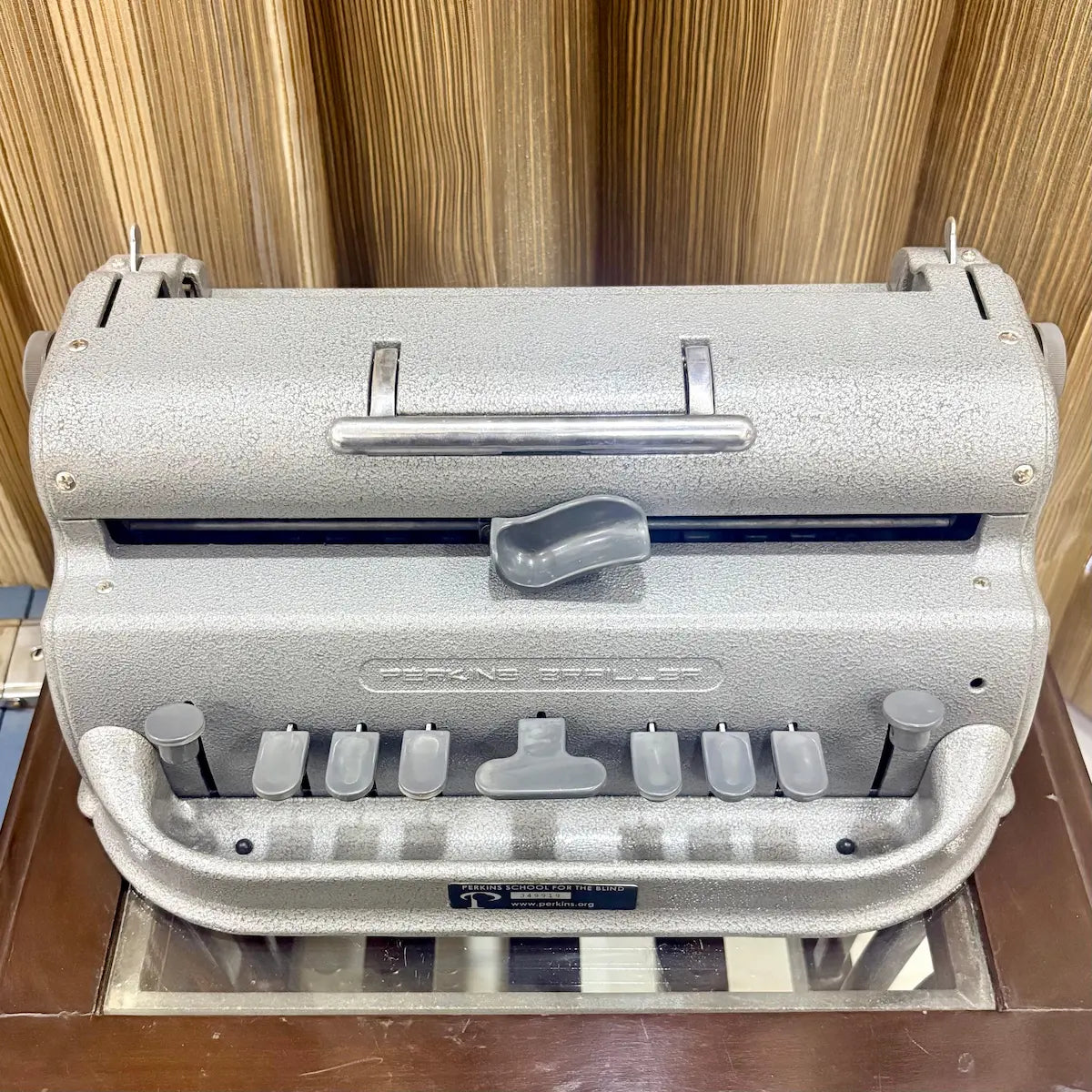 Perkins Braille Typewriter in mint grey with original factory paint and blue wooden case at RR Typewriter Mart in India today for sale.