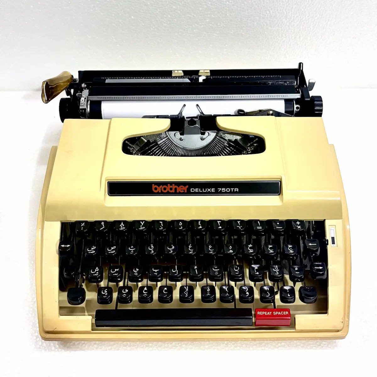 Arabic typewriter Brother 750TR in cream finish, showing Arabic keyboard, mechanical typebars and portable Japanese design for use
