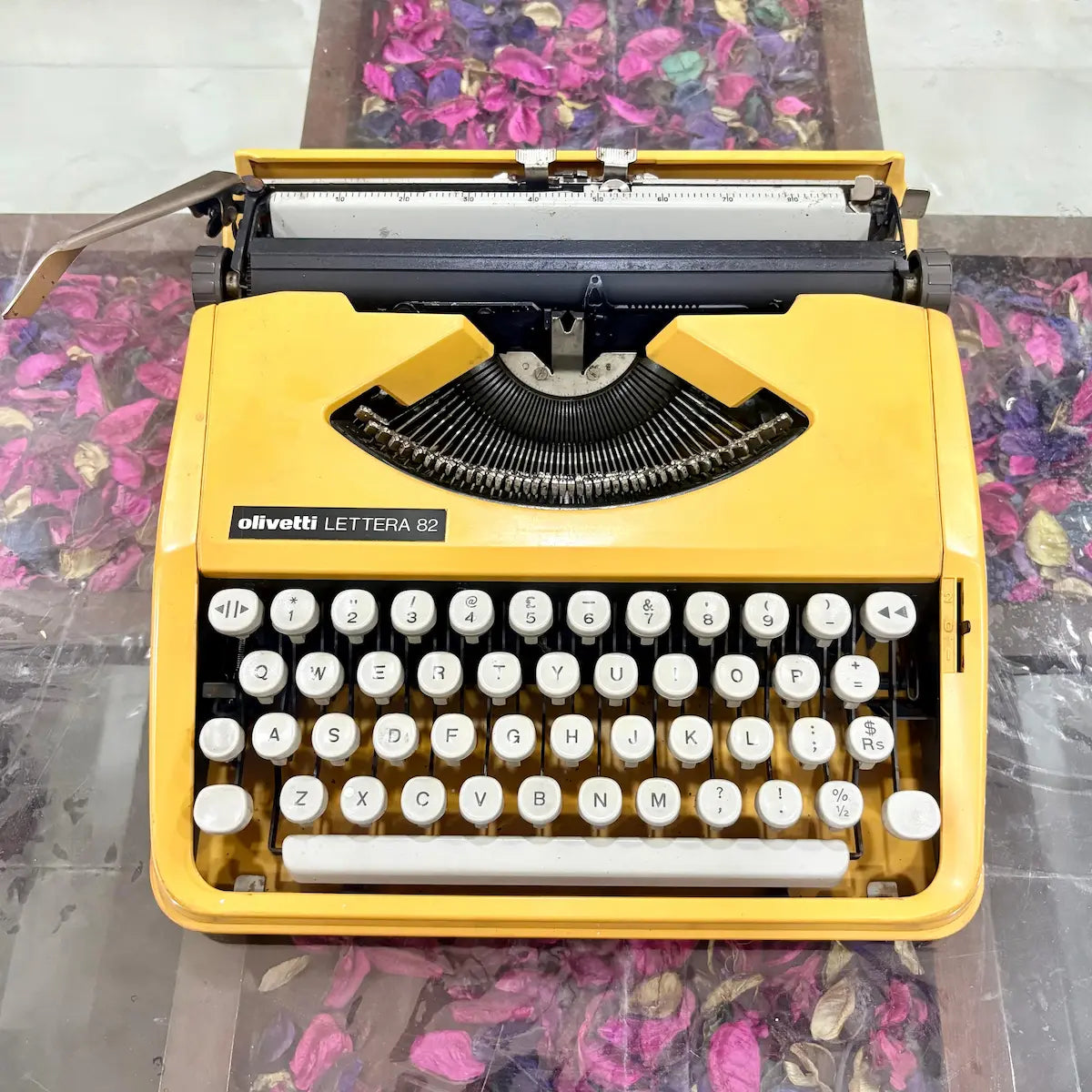 Front view of yellow Olivetti Lettera 82 manual typewriter with English QWERTY keys, RR Typewriter Mart