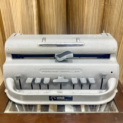 Front view of the Perkins Brailler showing six Braille keys, space bar and grey finish at RR Typewriter Mart for Braille users across India.
