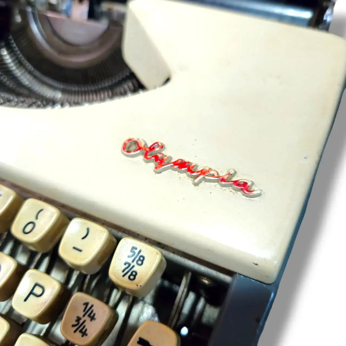 Detailed Olympia badge on portable typing machine from RR Typewriter Mart typewriter store India