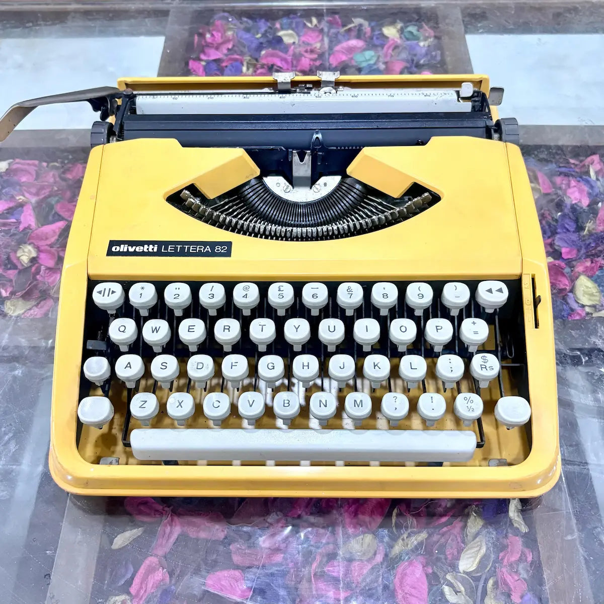 Yellow Olivetti Lettera 82 portable typewriter highlighting its keyboard and finish at RR Typewriter Mart