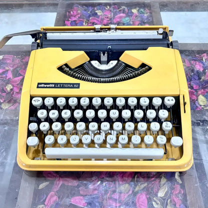 Yellow Olivetti Lettera 82 portable typewriter highlighting its keyboard and finish at RR Typewriter Mart