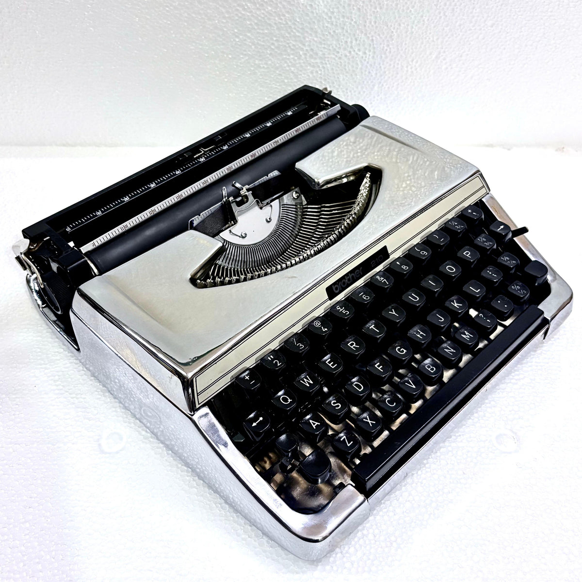 Brother 210 portable English typewriter in mirror chrome finish, restored and tested by RR Typewriter Mart