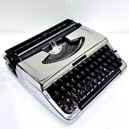Brother 210 portable English typewriter in mirror chrome finish, restored and tested by RR Typewriter Mart
