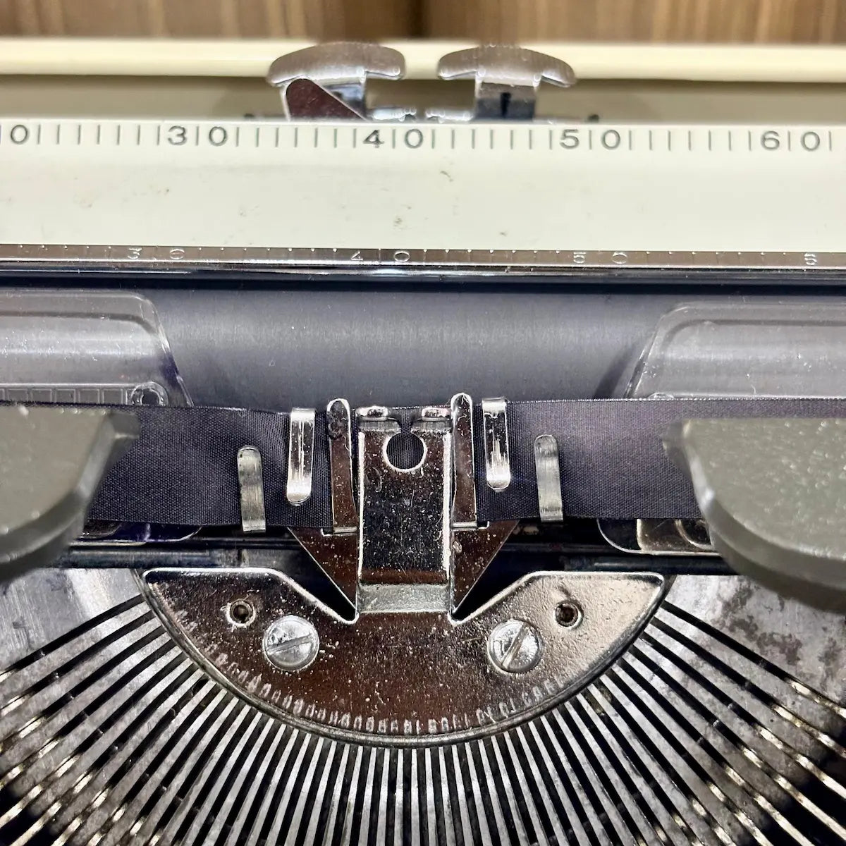 Japanese manual typewriter by Kovac featuring a two tone grey and ivory finish, classic keys and mechanical construction | RR Typewriter Mart