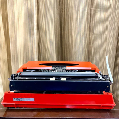 Brother Young Elite 513 portable typewriter, close-up of platen knobs and carriage controls on a scarlet red manual machine | RR Typewriter Mart