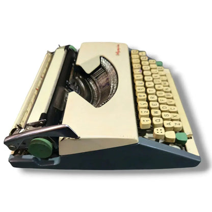 Angled top view of Olympia manual English typewriter with compact portable typing machine structure