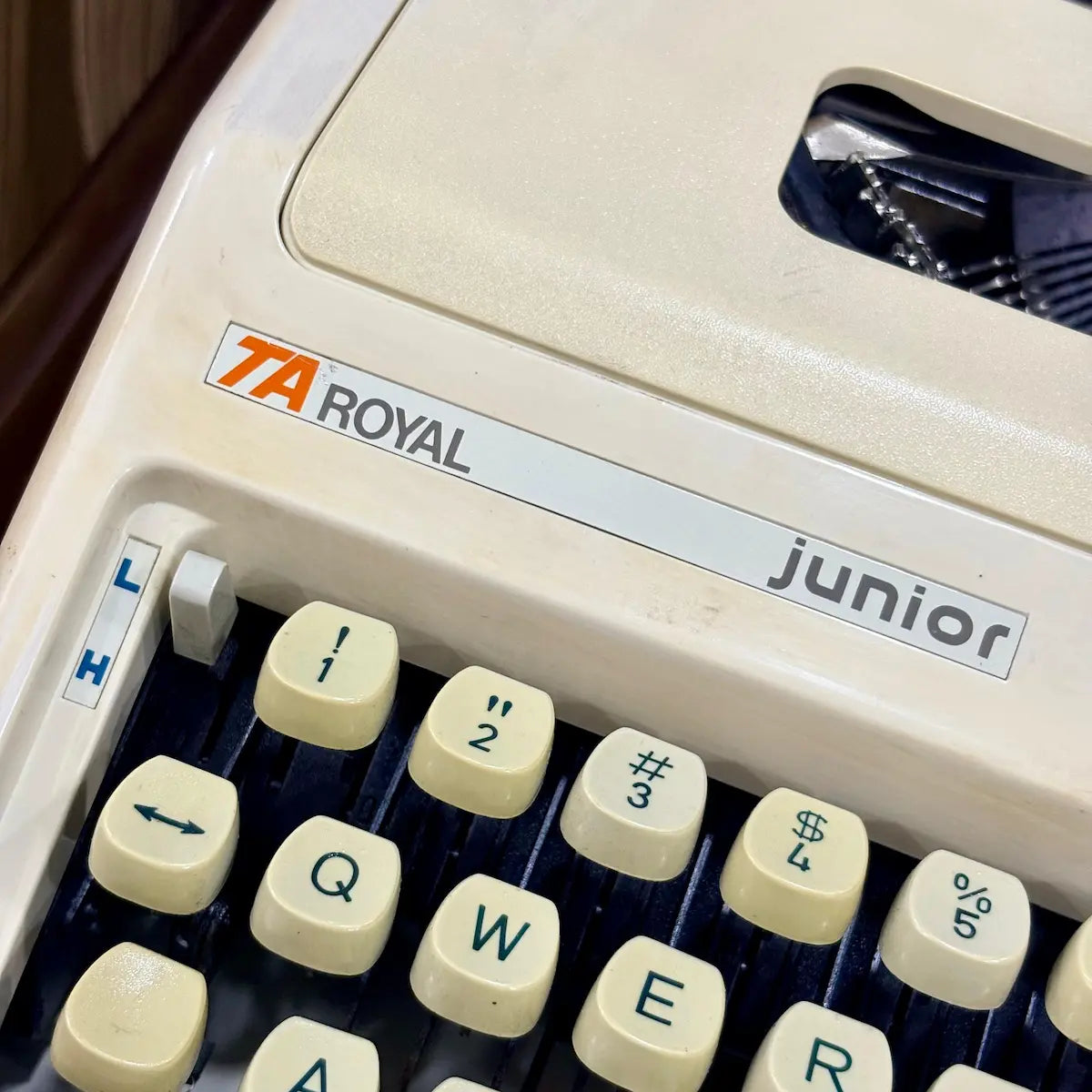 Royal Junior typewriter close-up showing Royal branding, cream body and mechanical keys, from RR Typewriter Mart.