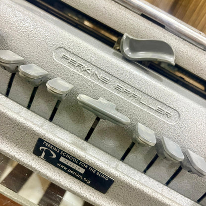 Close view of Perkins Brailler keys and mechanical writing area, showing grey finish at RR Typewriter Mart for Braille users in India.