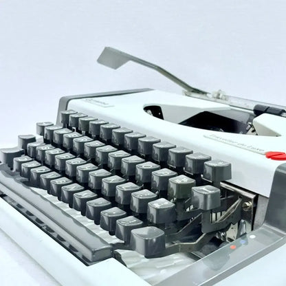 Professionally restored Olympia Traveller de Luxe classic portable typewriter