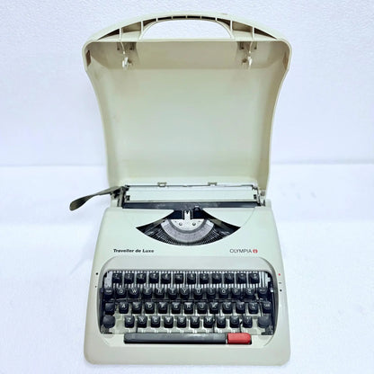 Front view of Olympia Traveller C manual typewriter, pearl white body, English keyboard, restored by RR Typewriter Mart!