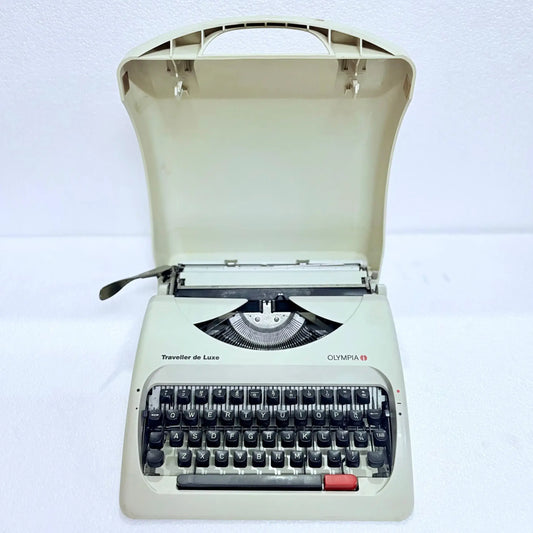 Front view of Olympia Traveller C manual typewriter, pearl white body, English keyboard, restored by RR Typewriter Mart!
