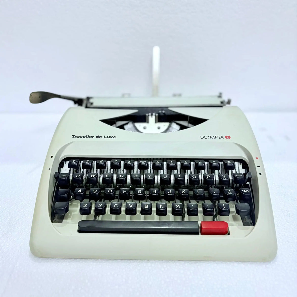 Side profile of Olympia typewriter with car inspired low design, pearl white manual typing machine by RR Typewriter Mart